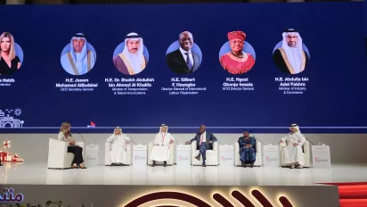 a group of people sitting on a stage in a panel discussion