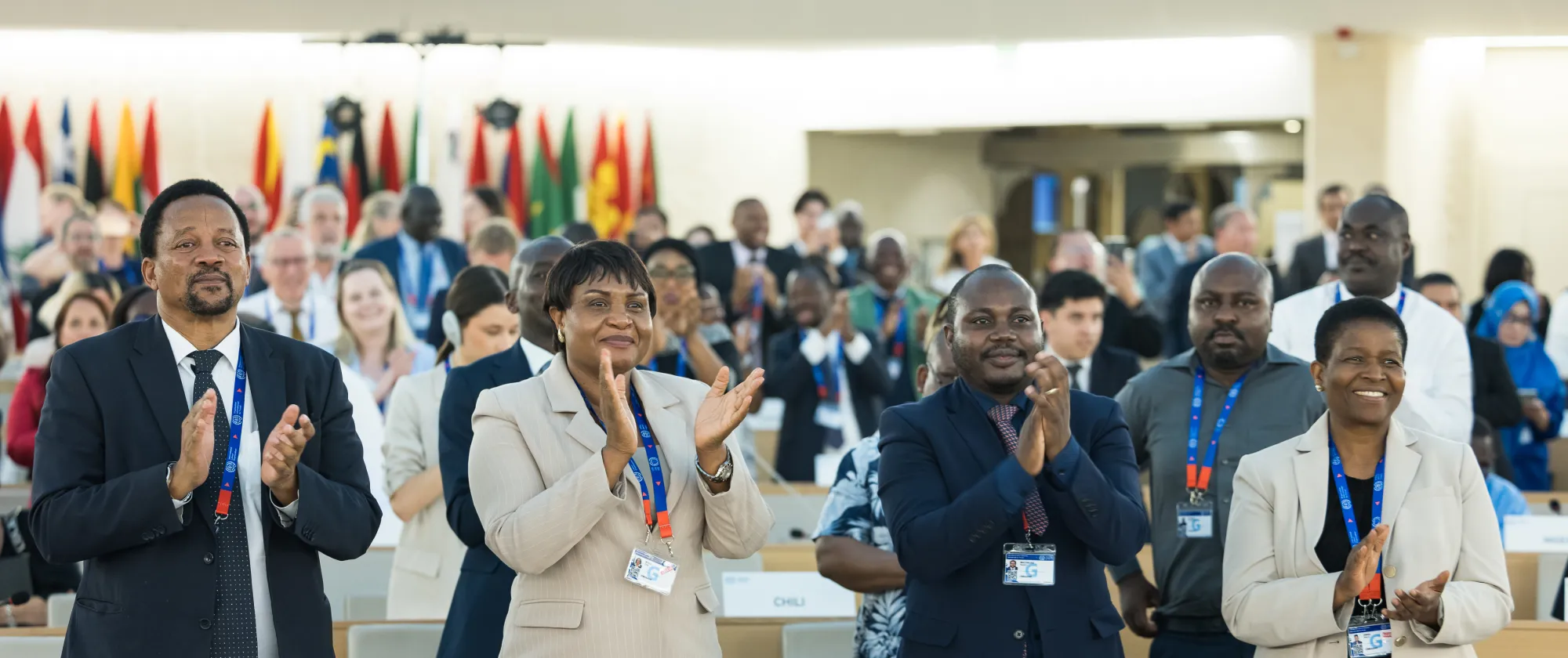 Delegates standing and applauding the end of the 113th International Labour Conference