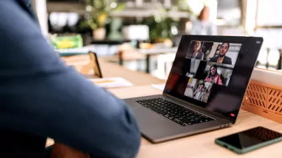 Stock photo of a computer screen showing a teleconference 