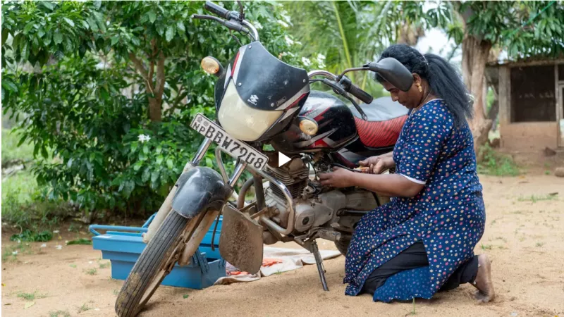 A woman next to a motorbike