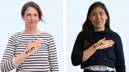 Two women with the hand placed on their heart with #C189 written on it